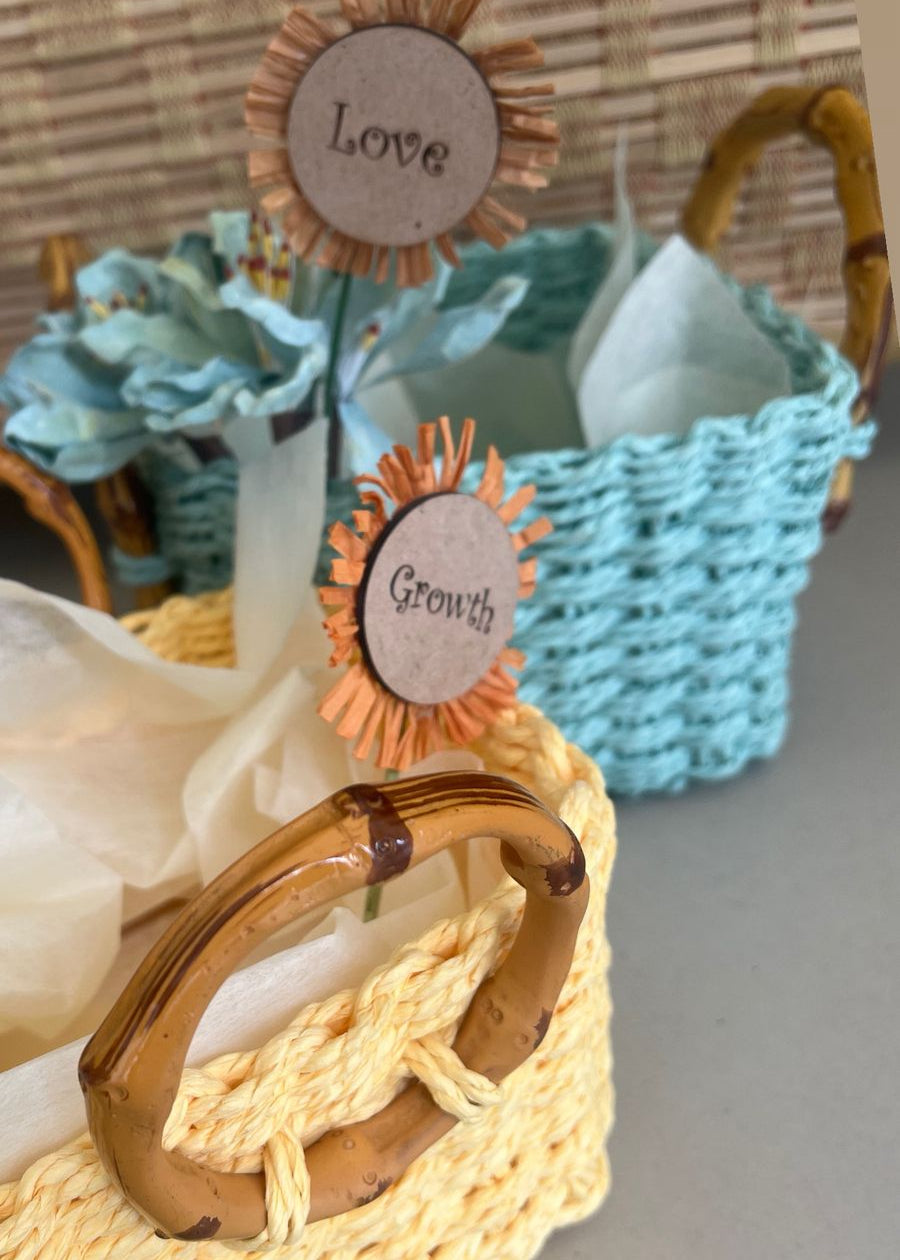 Decorative items with wooden signs labeled 'love' and 'growth' on a textured surface.